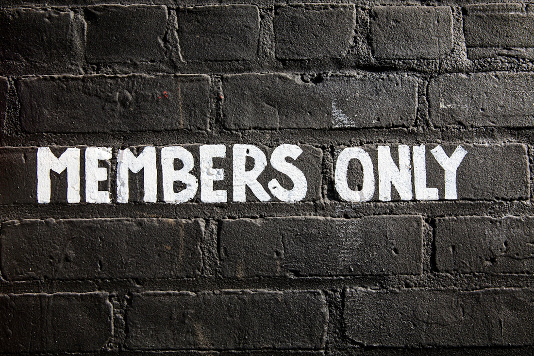 Members only sign on a brick wall